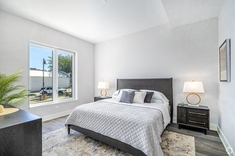 A bedroom with a large bed and a view of the outside.