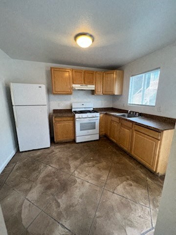 a small kitchen with a refrigerator and a stove
