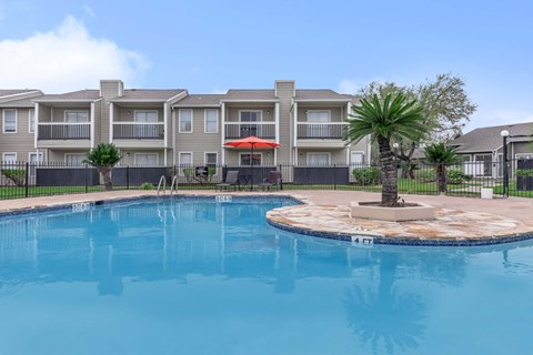 Resort style swimming pool with sundeck at Royal Wildewood Manor Apartments, Clute, 77531
