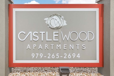 Property entrance sign with landscaping at Castlewood Apartments, Clute