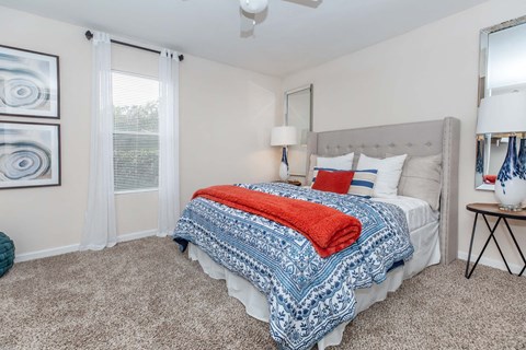 Bedroom with tufted headboard and patterned bedding at Royal Wildewood Manor Apartments, Clute, 77531