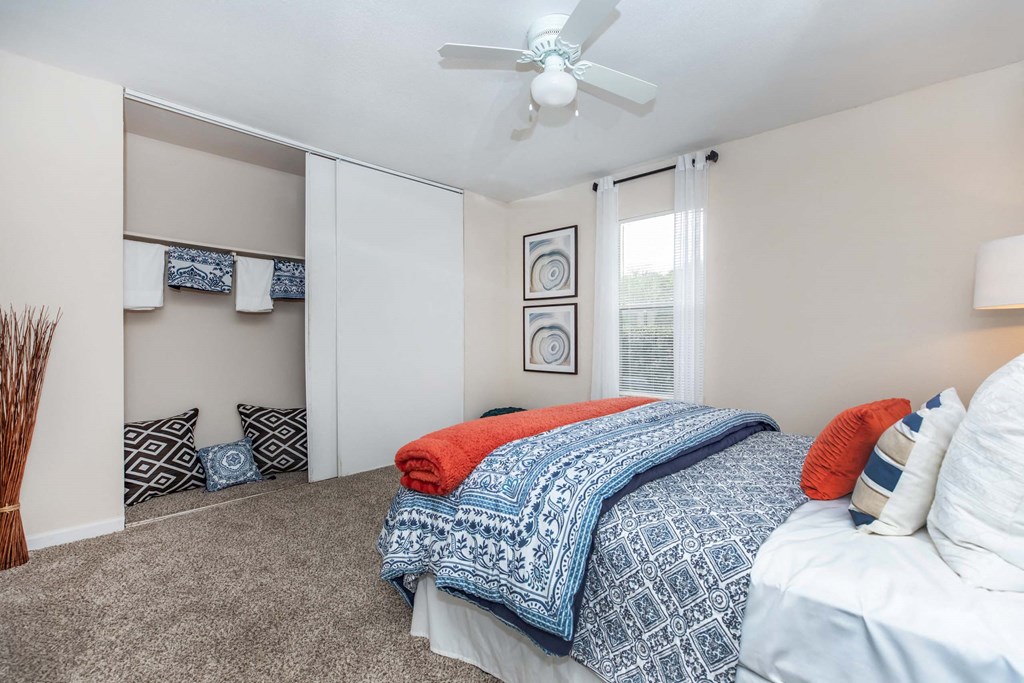 Bedroom with cozy bed and lampat Royal Wildewood Manor Apartments, Clute