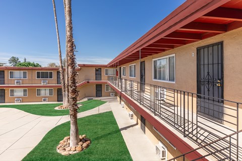 Exterior walkway with metal railings and courtyard at Oakridge Apartments, California