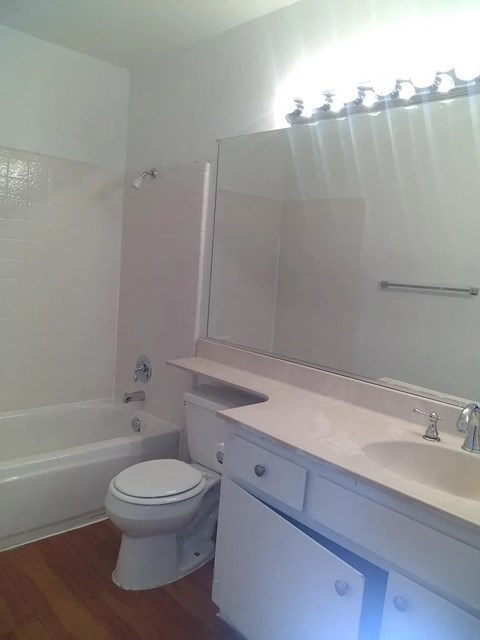 a white bathroom with a toilet and a sink