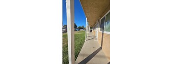 a view of the outside of a building with a sidewalk