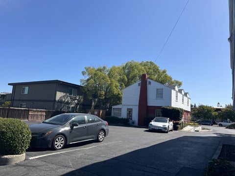 A silver car is parked in a parking lot.