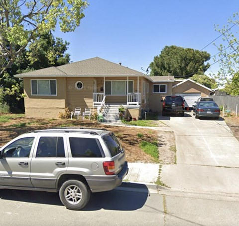 a house with a silver car parked in front of it
