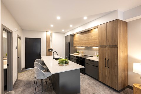 A modern kitchen with a dining table and chairs.