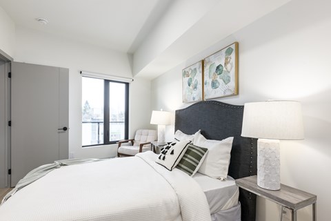 A bedroom with a large bed and a window.