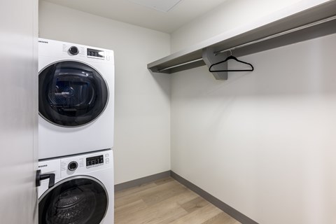 A white washing machine in a small laundry room.