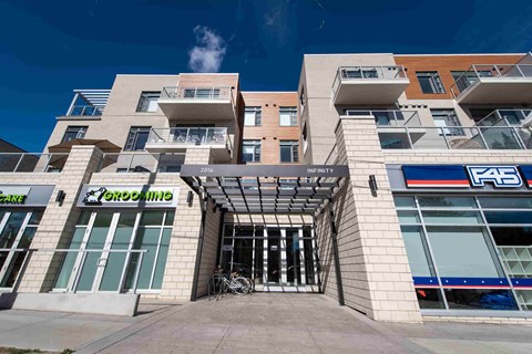 A modern building with a glass entrance and a sign that reads "INFINITY".