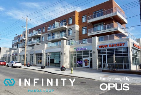 A building with a sign that says "INFINITY" and "Marda Loop" on it.