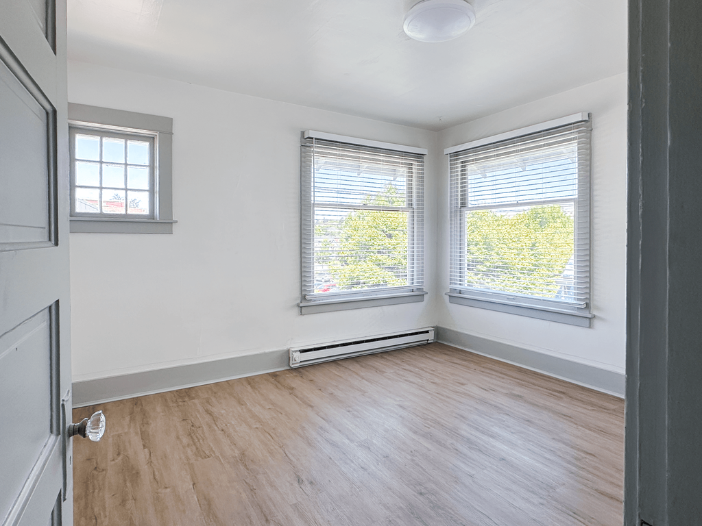 A room with a window and a door.