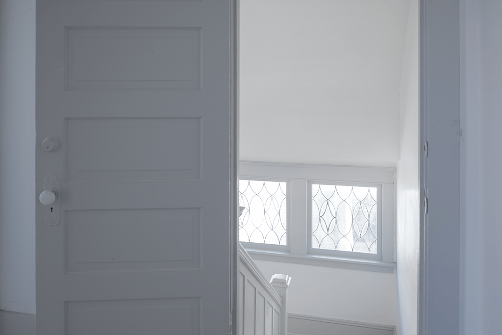 A white door with a window above it.