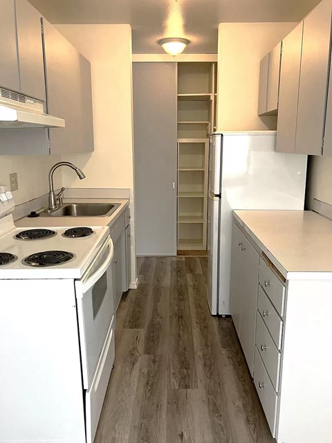 a small kitchen with a stove and a refrigerator