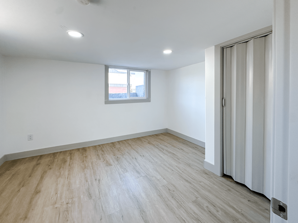 A room with a window and a sliding door.