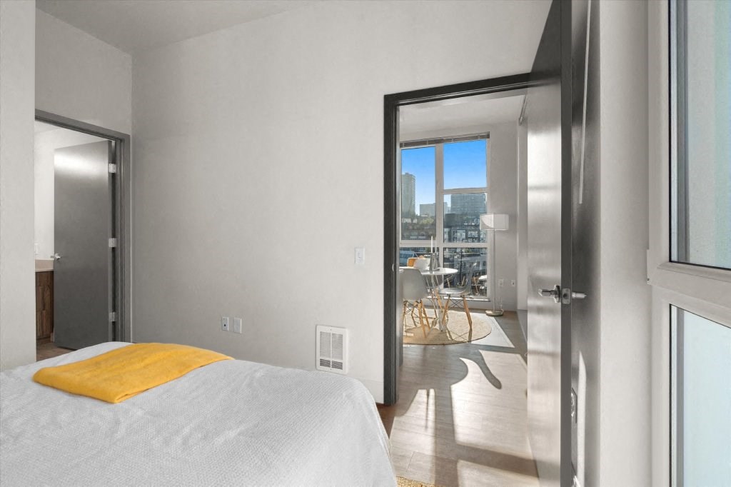 a bedroom with a bed and a door to a balcony