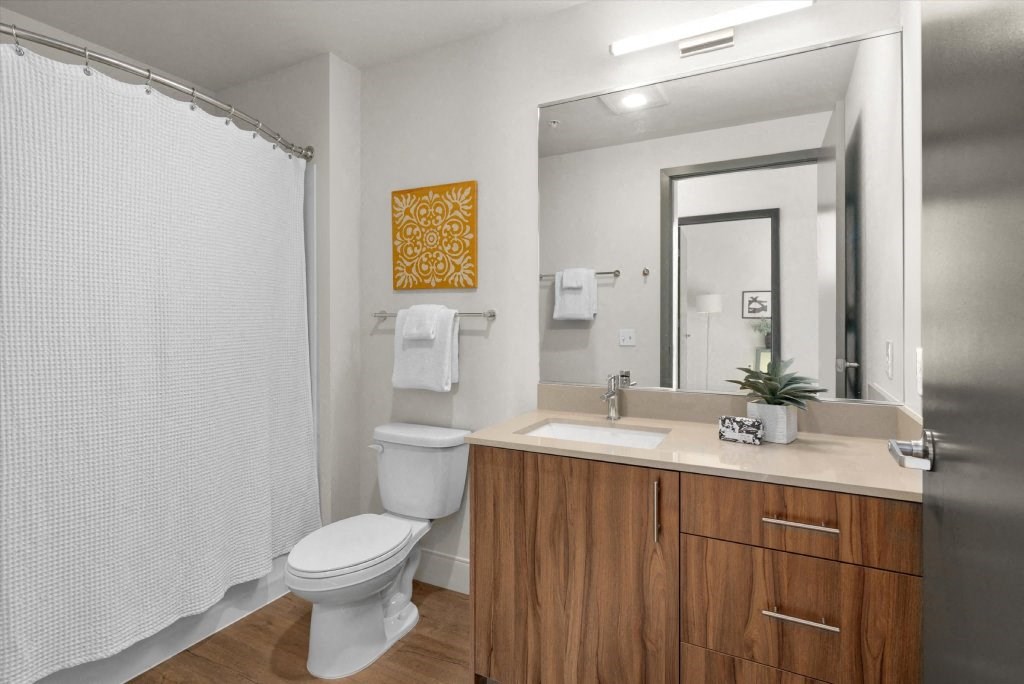 a bathroom with a toilet sink and a mirror