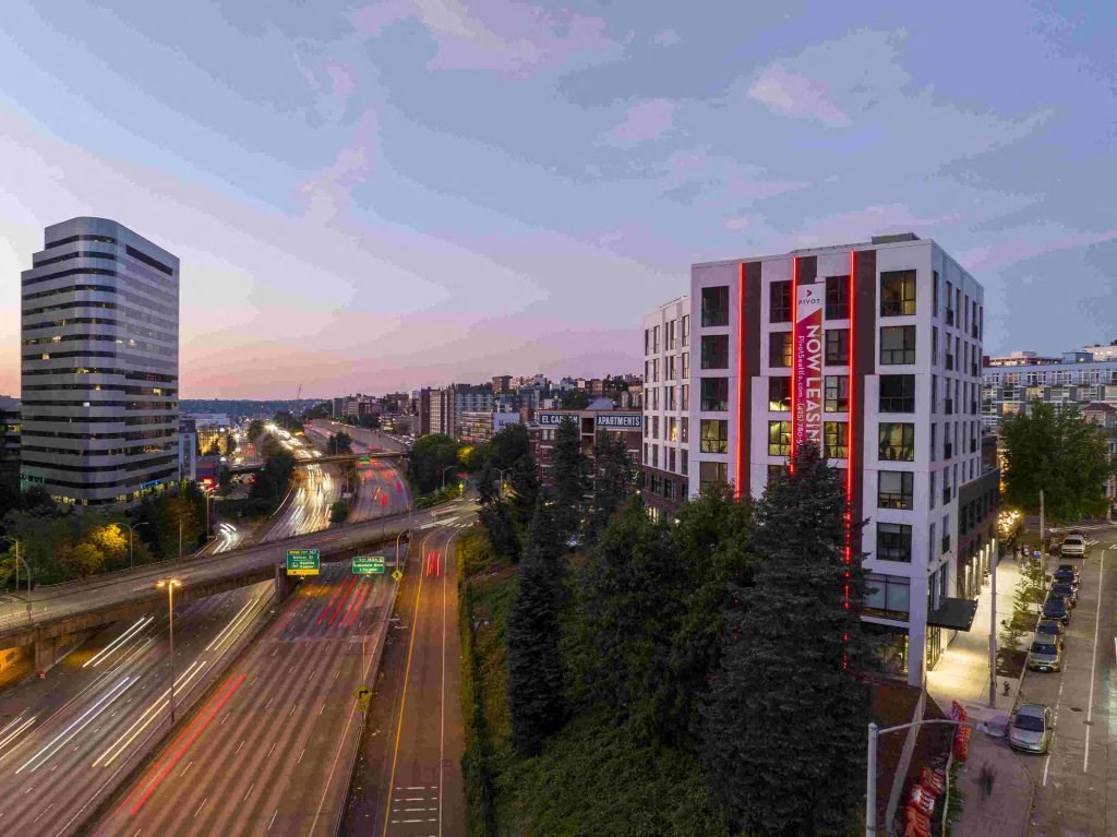 a view of the city from a high rise building at dusk