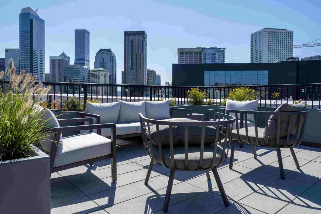 a rooftop patio with a city skyline in the background