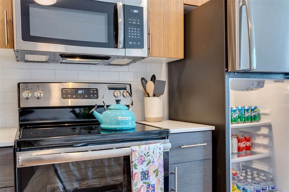a kitchen with a stove and a microwave and a refrigerator