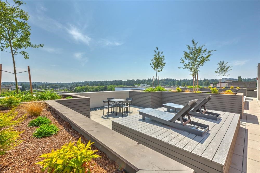 a rooftop terrace with benches and tables