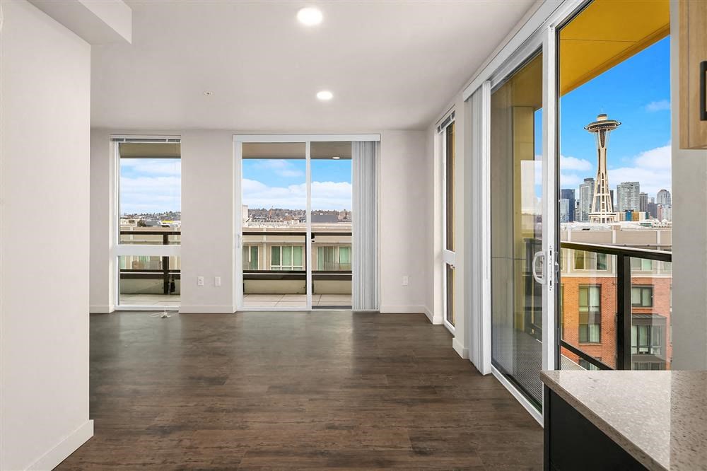 a living room with a view of the city and a balcony