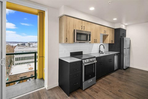 a kitchen with a stove and a refrigerator and a window
