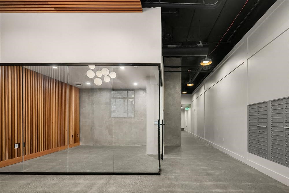 a lobby with a glass door and a wooden wall