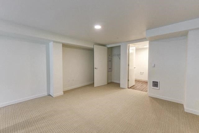an empty living room with white walls and a carpet
