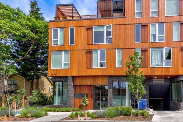 the facade of a building with a tree in front of it