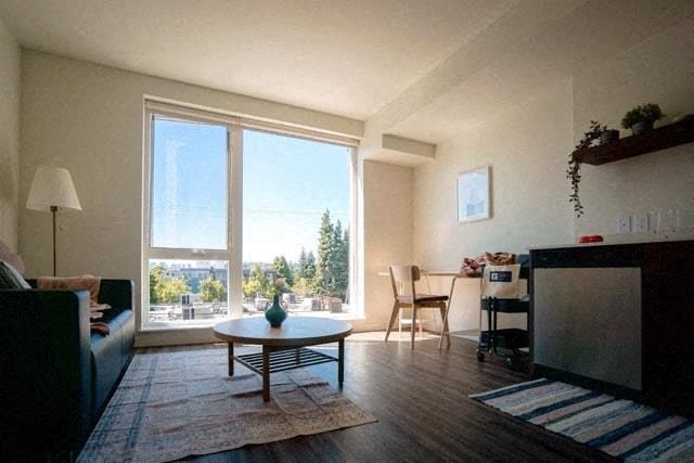 a living room with a couch and a table and a large window