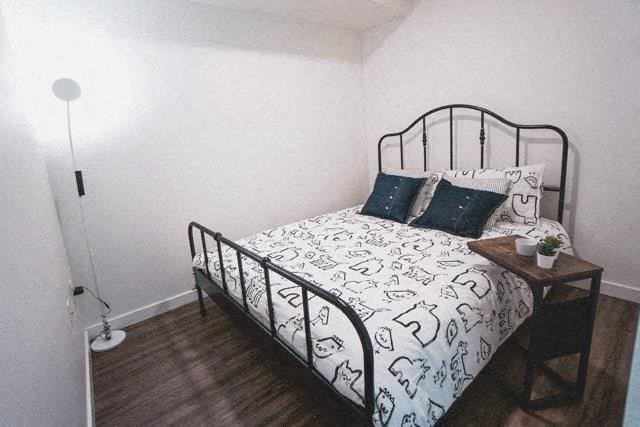 a small bedroom with a bed and a night stand