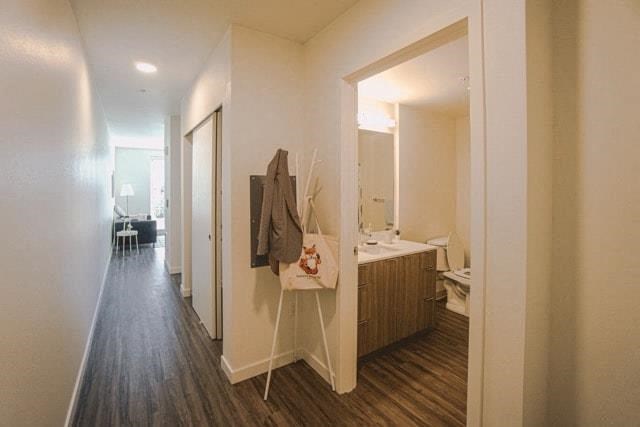 a bathroom with a mirror and a robe on a rack