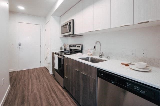a kitchen with a sink and a stove and a microwave