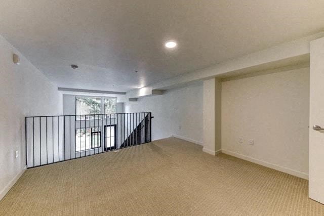 an empty living room with a staircase and a window