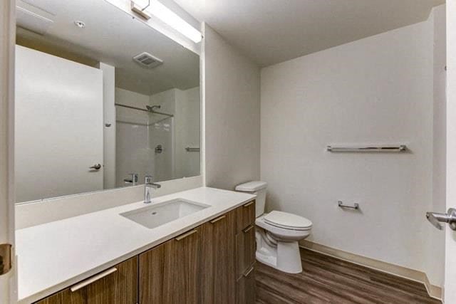 a bathroom with a toilet and a sink and a mirror