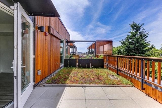 a backyard with a patio and a wooden fence