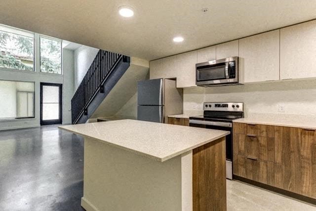 a kitchen with an island and a stove and a microwave