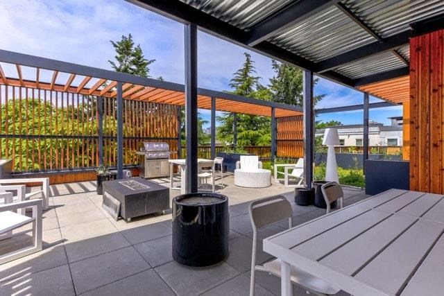 a patio with a table and chairs and glass doors