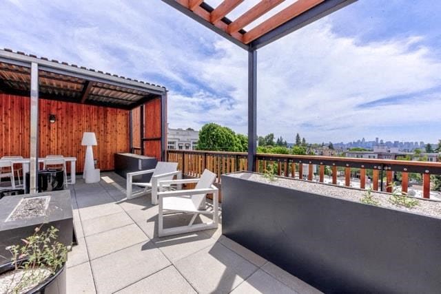 a balcony with patio furniture and a view of the city