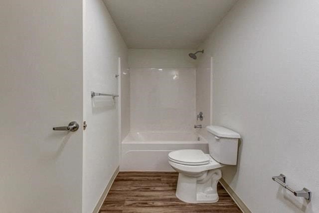a bathroom with a white toilet and a bath tub