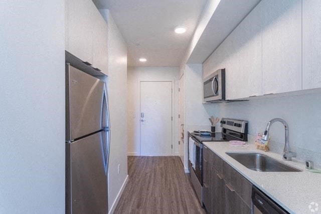a kitchen with a sink and a refrigerator