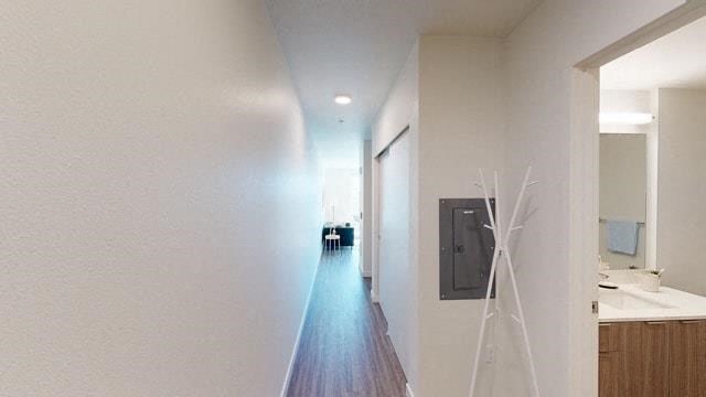 a long hallway with a door and a mirror