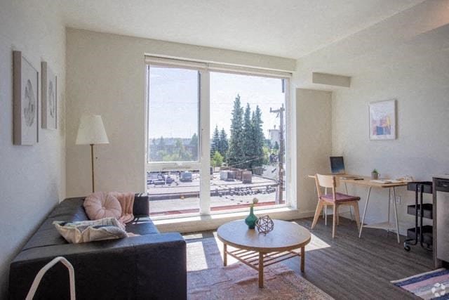 a living room with a couch and a table and a large window