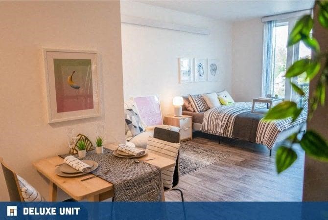 a living room with a bed and a table