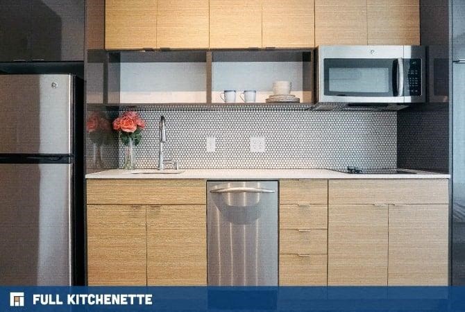 a kitchen with a sink and a refrigerator and a microwave