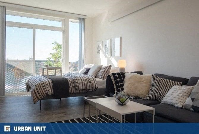 a living room with a couch and a large window