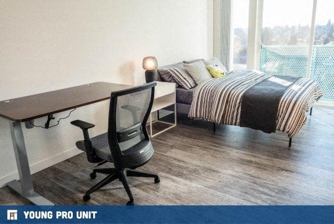 a bedroom with a bed and a desk and a chair