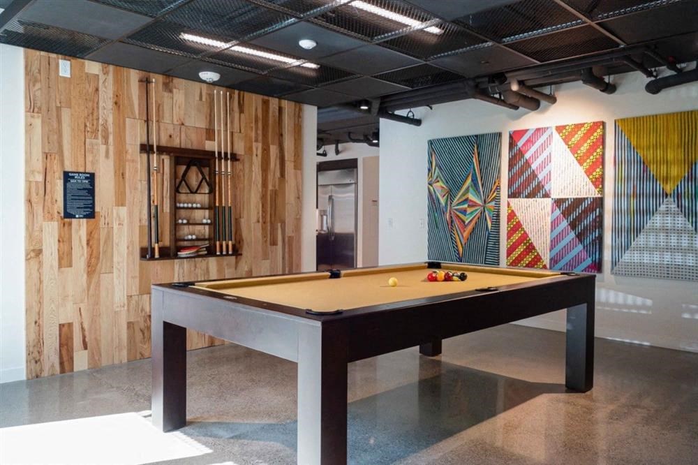 a billiards table in the lobby of an art gallery